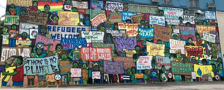 mural of people holding different signs
